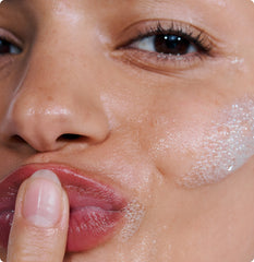 Model with Pineapple Refresh Cleanser foamed up on skin